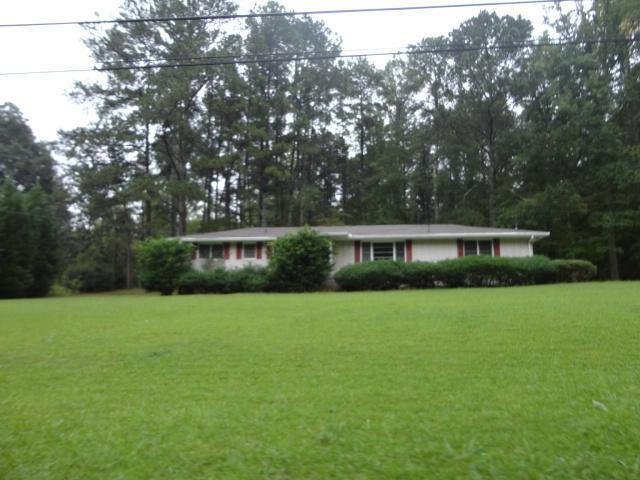 6230 Jones Road College Park, GA 30349 - Photo 1 of 1 a front view of a house with a garden