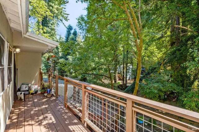 a view of balcony with wooden floor and fence