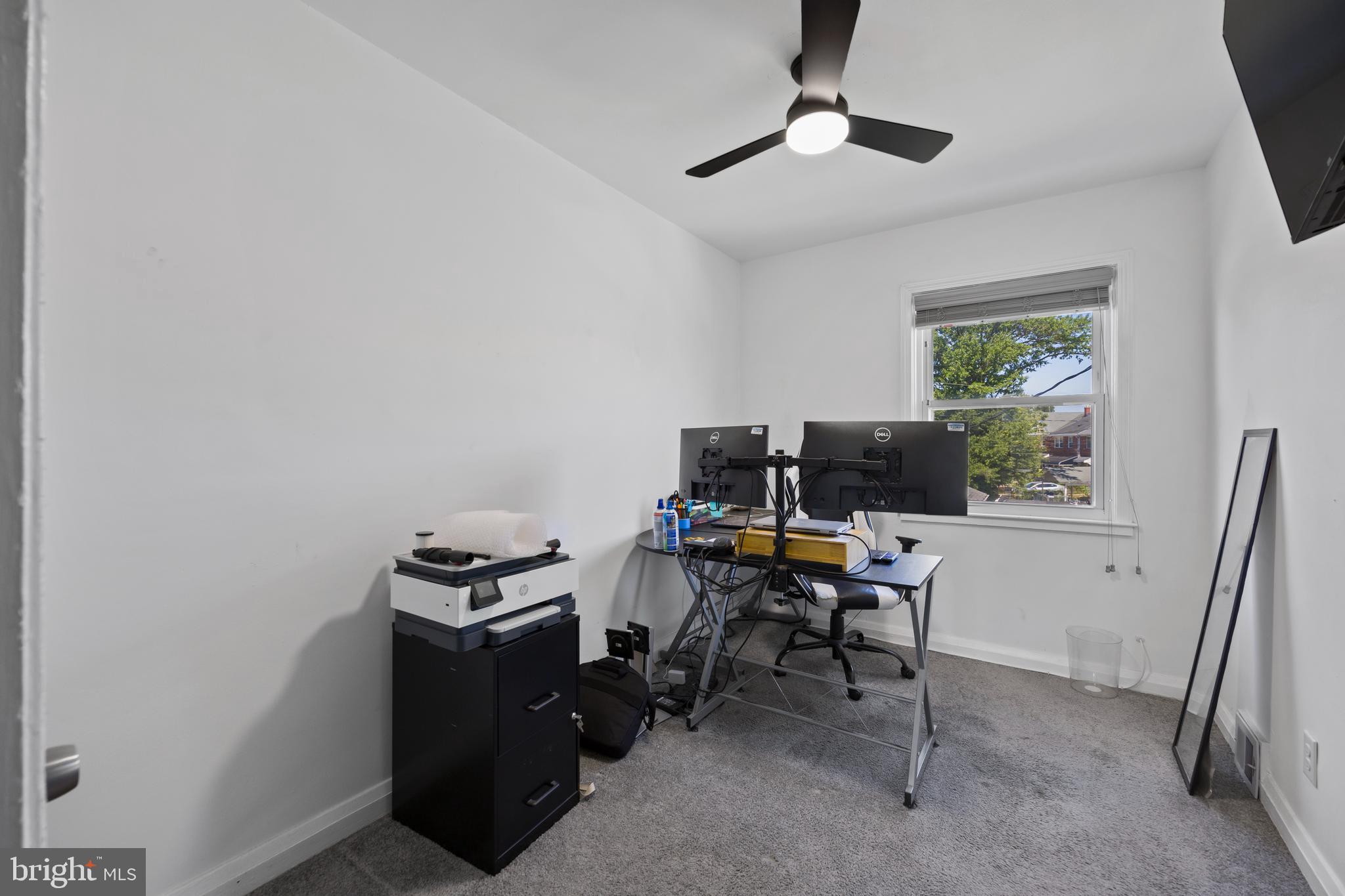 4511 Marble Hall Road Baltimore, MD 21239 - Photo 31 of 48 a view of a workspace with furniture and a window