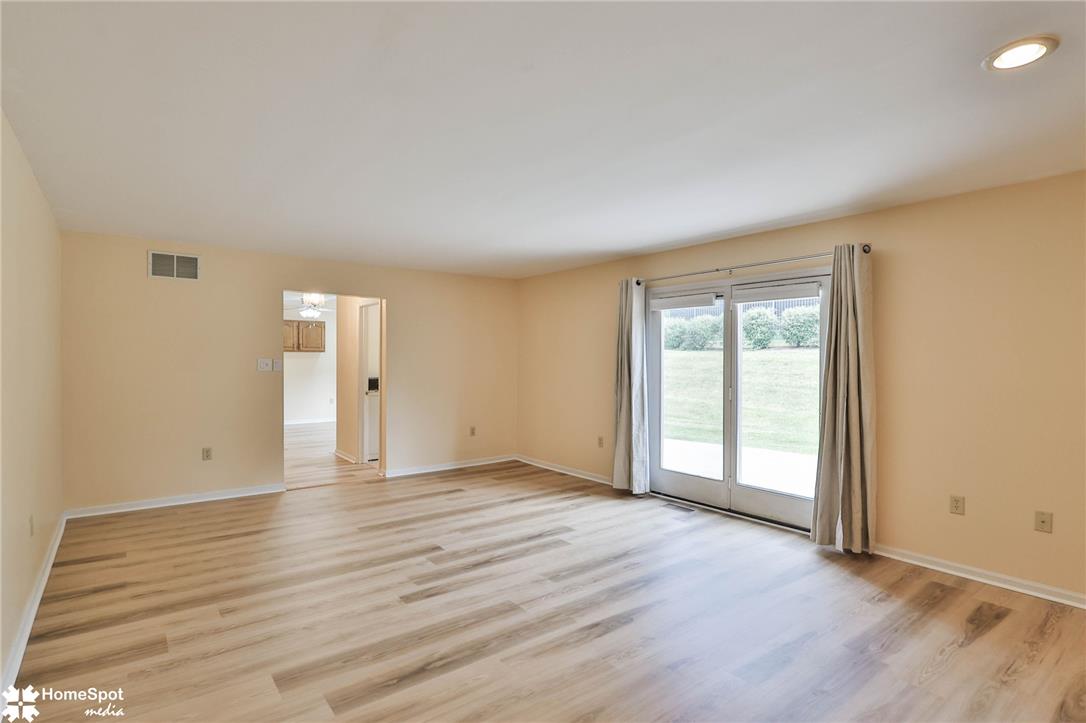 4059 Wedgewood Road Allentown, PA 18104 - Photo 26 of 72 Laminate flooring graces this generous living area with abundant natural illumination from the sliding doors.