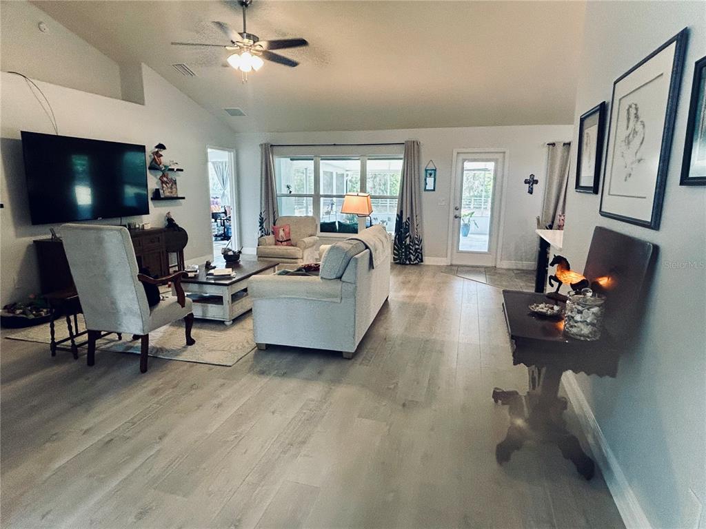 25 Northwest 45th Loop Ocala, FL 34475 - Photo 16 of 61 a living room with furniture and a flat screen tv