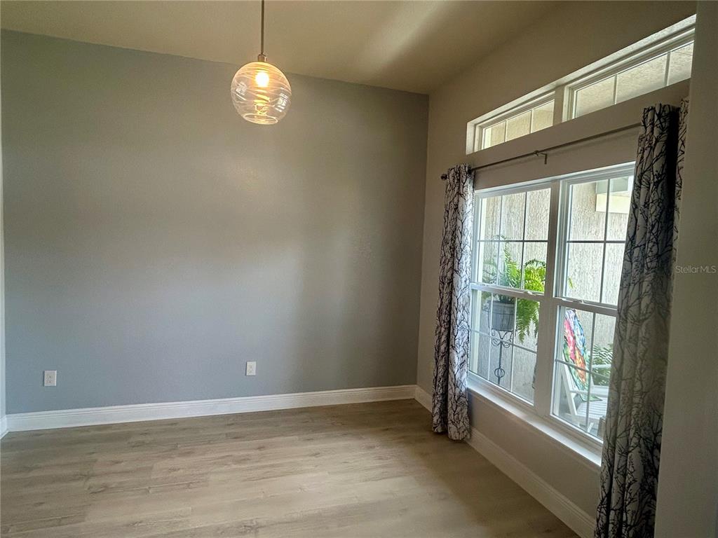 25 Northwest 45th Loop Ocala, FL 34475 - Photo 19 of 61 a view of an empty room with wooden floor and a window