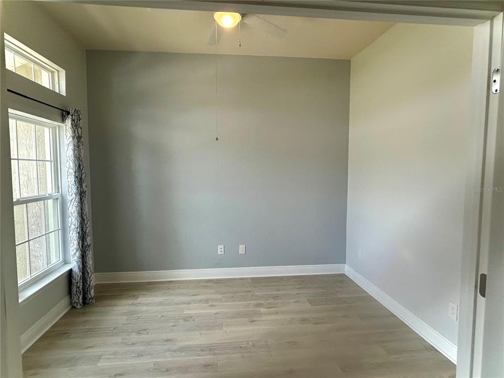 25 Northwest 45th Loop Ocala, FL 34475 - Photo 21 of 61 a view of an empty room with wooden floor and a window