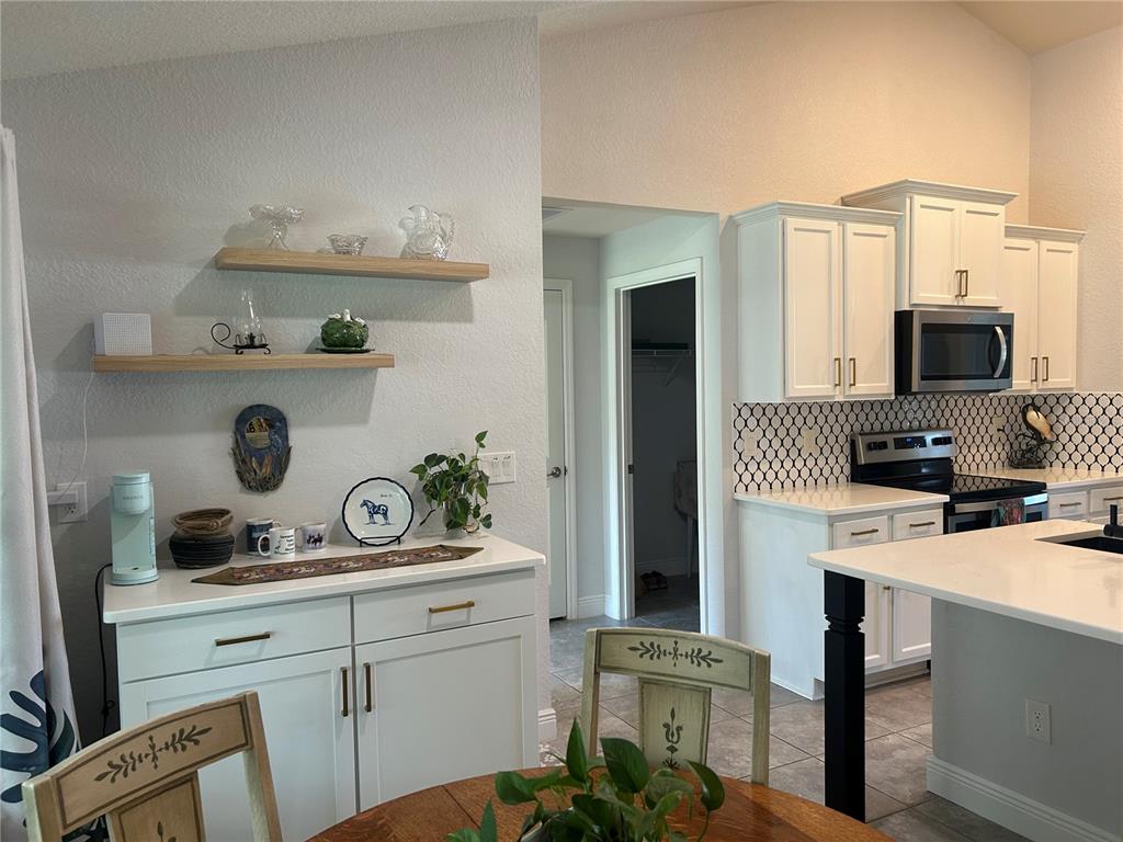 25 Northwest 45th Loop Ocala, FL 34475 - Photo 25 of 61 a kitchen with a sink stove and refrigerator