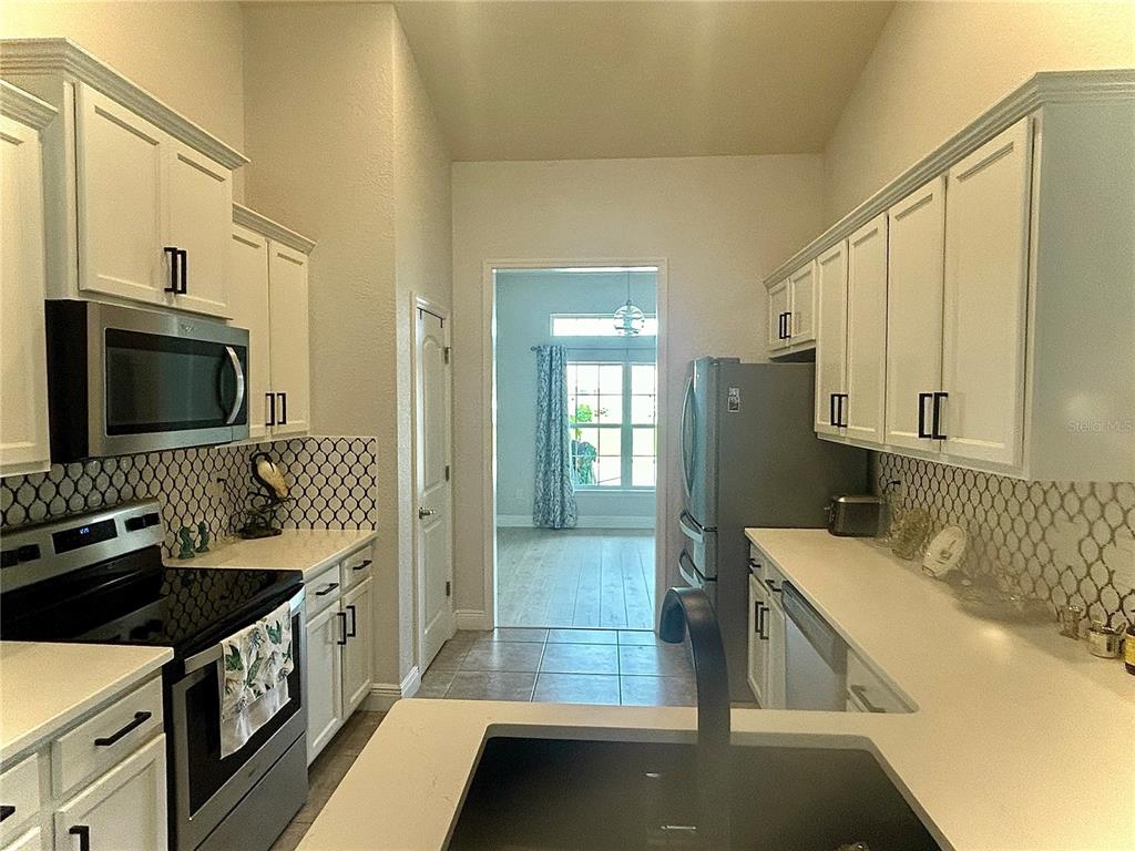 25 Northwest 45th Loop Ocala, FL 34475 - Photo 30 of 61 a kitchen with a sink and a stove top oven