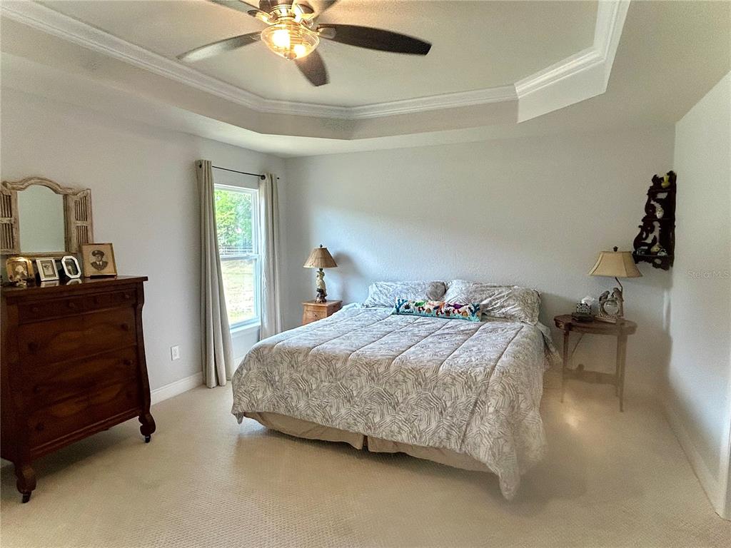 25 Northwest 45th Loop Ocala, FL 34475 - Photo 31 of 61 a bedroom with a bed and a table