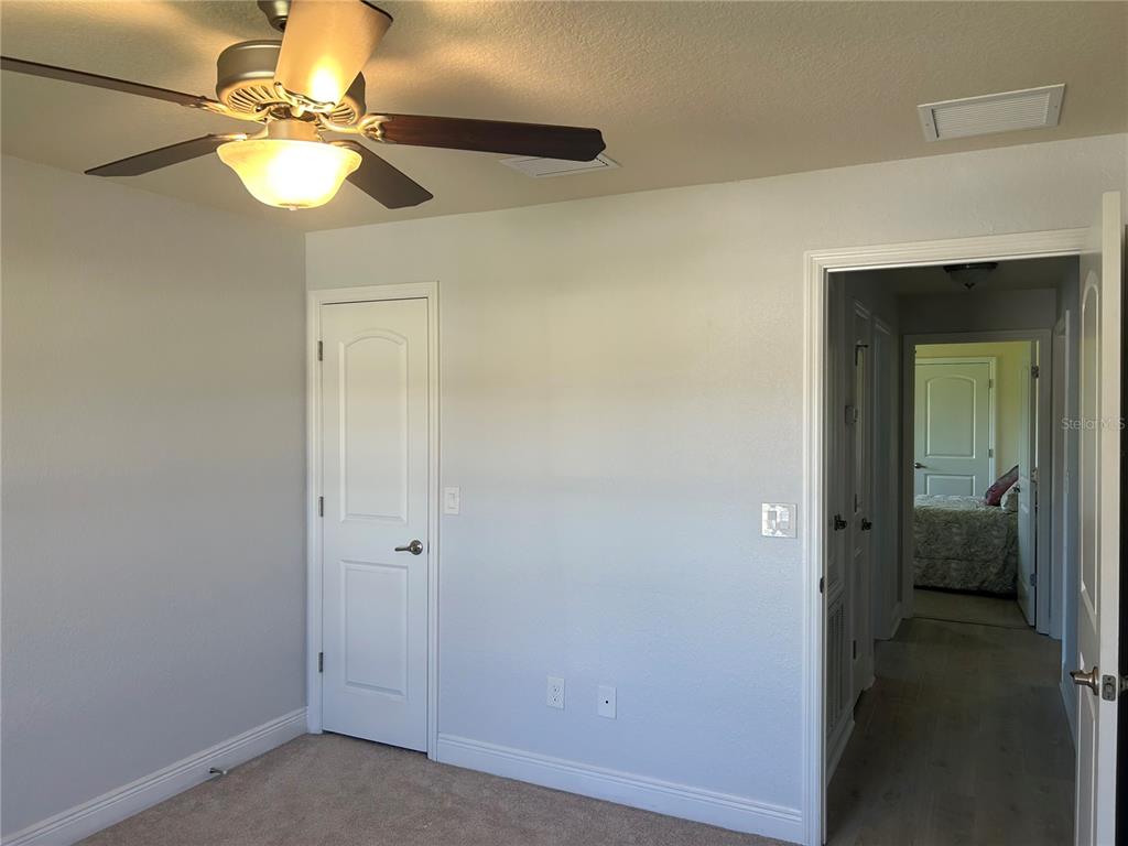 25 Northwest 45th Loop Ocala, FL 34475 - Photo 45 of 61 a view of a room with a chandelier fan and closet