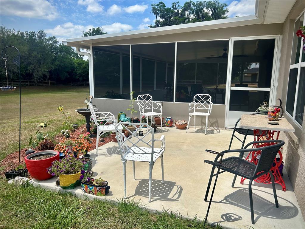 25 Northwest 45th Loop Ocala, FL 34475 - Photo 53 of 61 a view of a patio with table and chairs and potted plants
