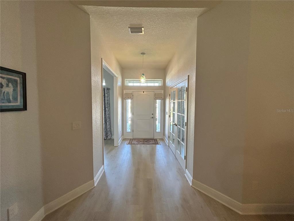 25 Northwest 45th Loop Ocala, FL 34475 - Photo 9 of 61 a view of a hallway with wooden floor