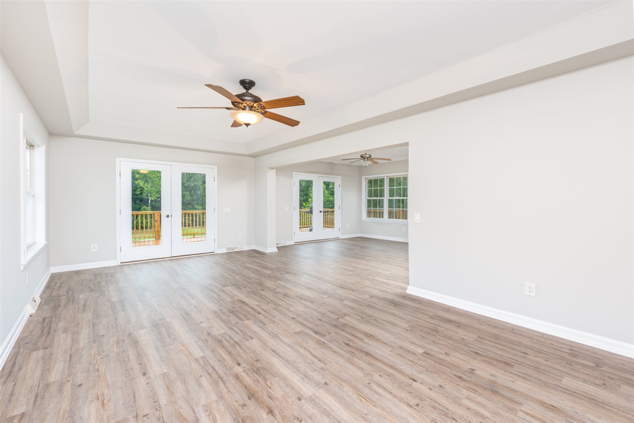 561 Rife's Ford Road Verona, VA 24482 - Photo 19 of 50 an empty room with wooden floor ceiling fan and windows
