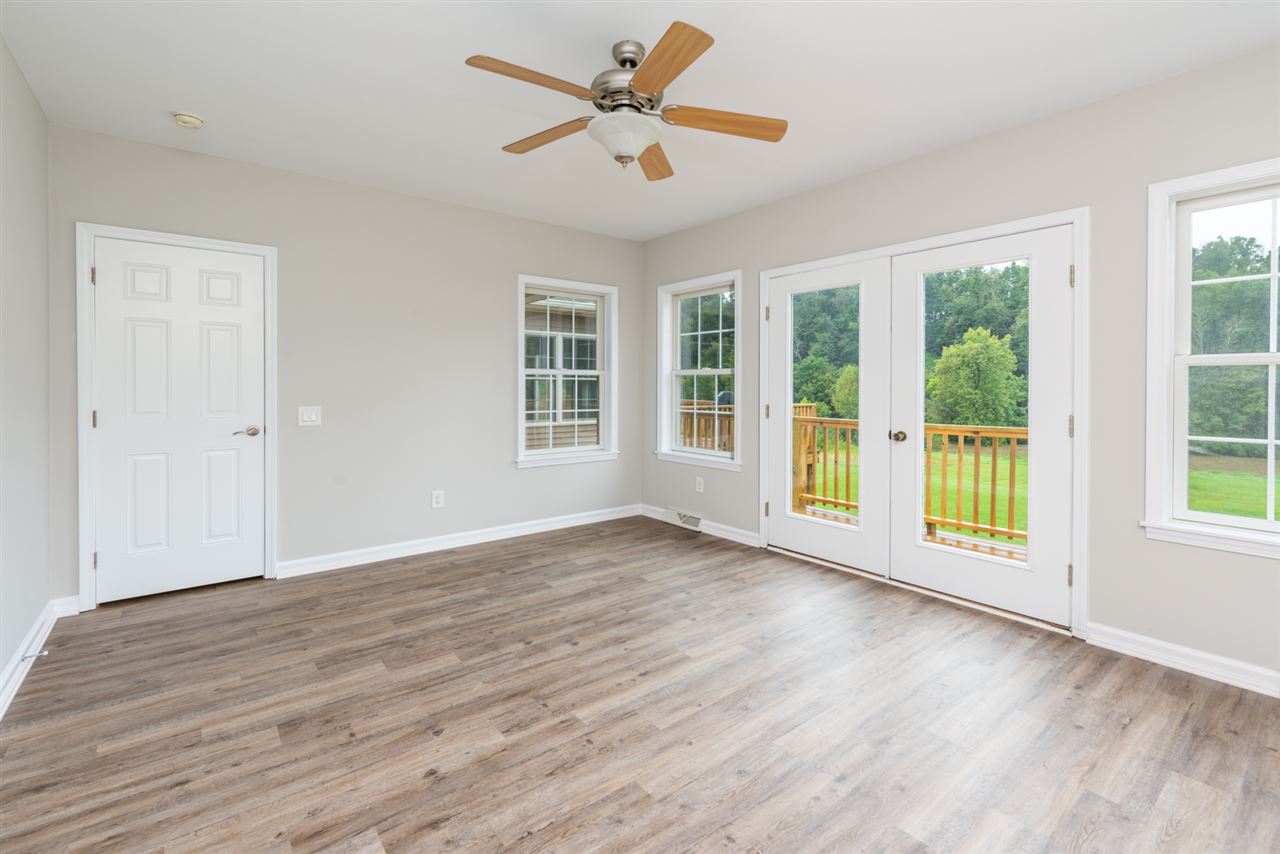 561 Rife's Ford Road Verona, VA 24482 - Photo 21 of 50 a view of an empty room with a window and wooden floor
