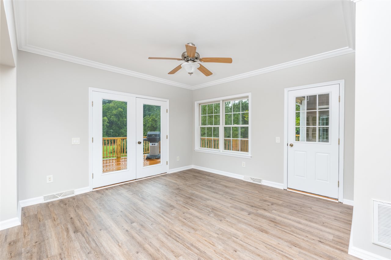 561 Rife's Ford Road Verona, VA 24482 - Photo 25 of 50 an empty room with wooden floor ceiling fan and windows