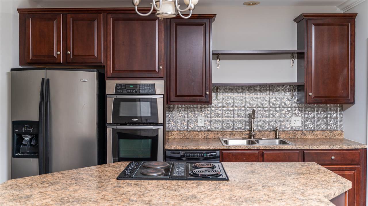561 Rife's Ford Road Verona, VA 24482 - Photo 27 of 50 a kitchen with wooden cabinets and a stove top oven
