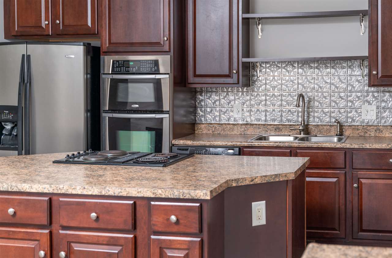561 Rife's Ford Road Verona, VA 24482 - Photo 32 of 50 a kitchen with granite countertop a sink and a refrigerator