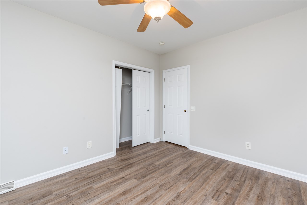 561 Rife's Ford Road Verona, VA 24482 - Photo 44 of 50 an empty room with wooden floor and chandelier fan