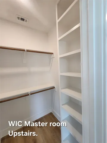 a view of walk in closet with empty racks
