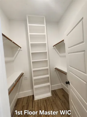 a view of walk in closet with empty racks