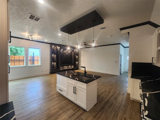 a kitchen with stainless steel appliances granite countertop a stove and a refrigerator