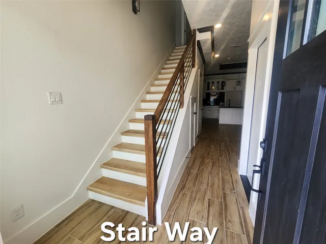 a view of entryway and gallery with wooden floor