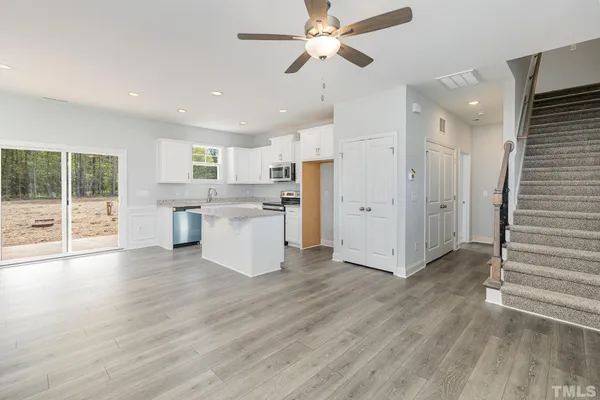 a view of a kitchen with wooden floor and a window