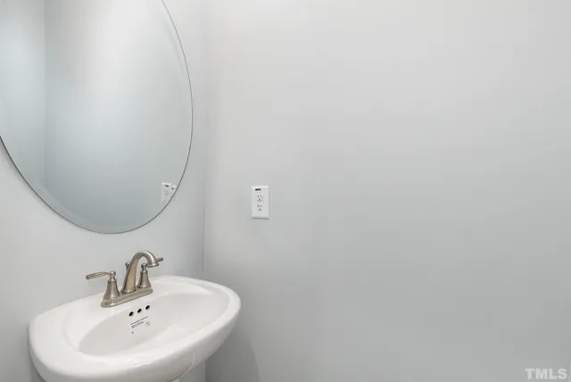 a bathroom with a sink and mirror