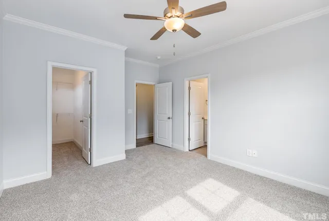 a view of a room with a ceiling fan and closet area