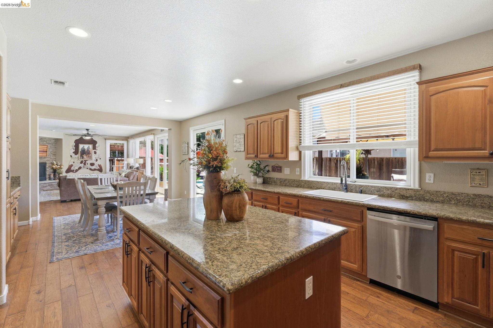 3438 Keystone Loop Discovery Bay, CA 94505 - Photo 12 of 57 Kitchen featuring a central island with a granite countertop, wood-finish flooring, and recessed lighting