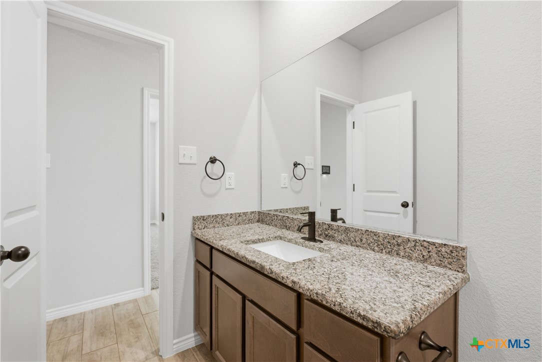 3201 Hedwig Street Killeen, TX 76549 - Photo 25 of 38 a bathroom with a granite countertop sink and a mirror