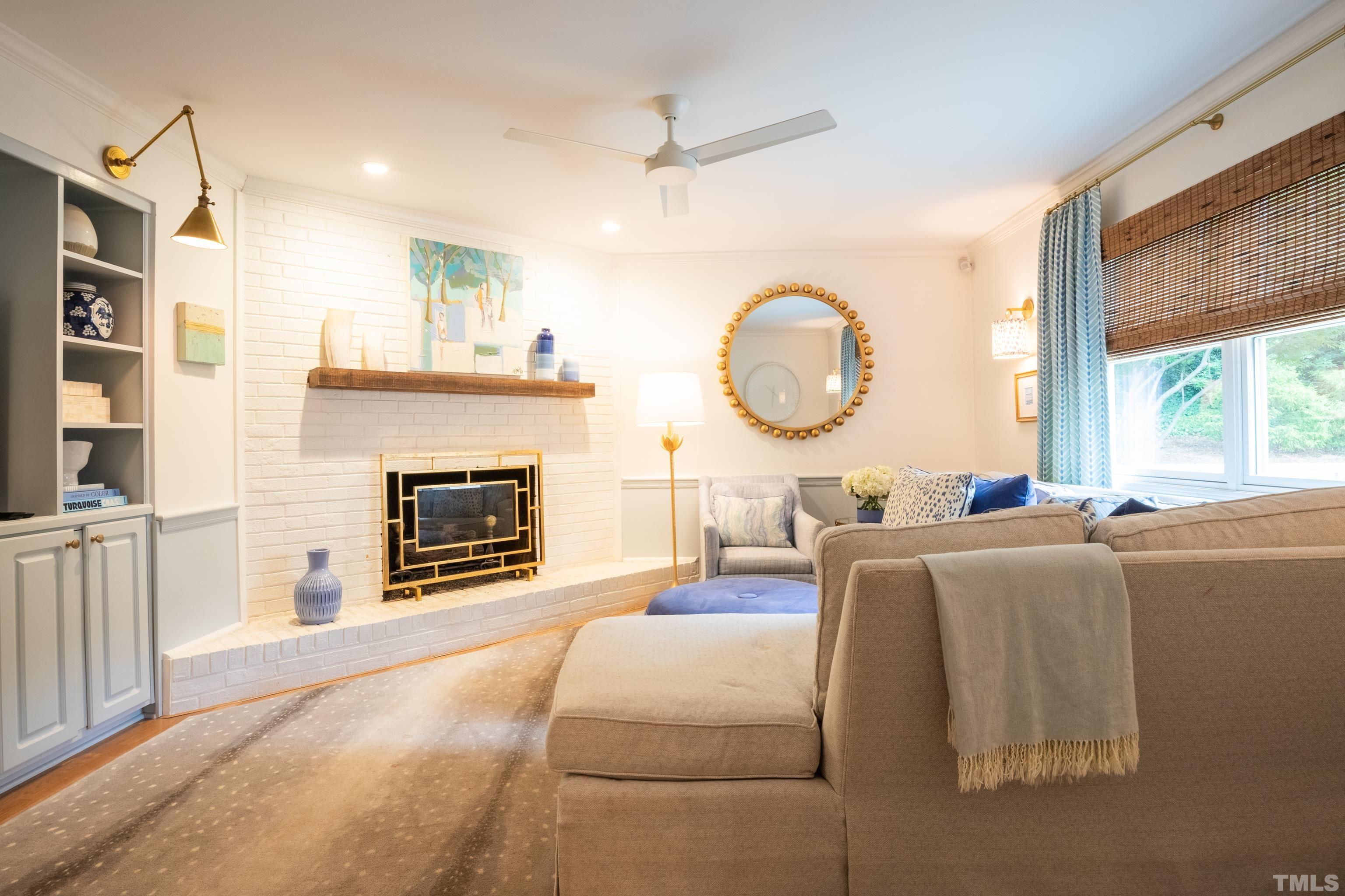816 Davidson Street Raleigh, NC 27609 - Photo 18 of 36 a living room with furniture a fireplace and a large window
