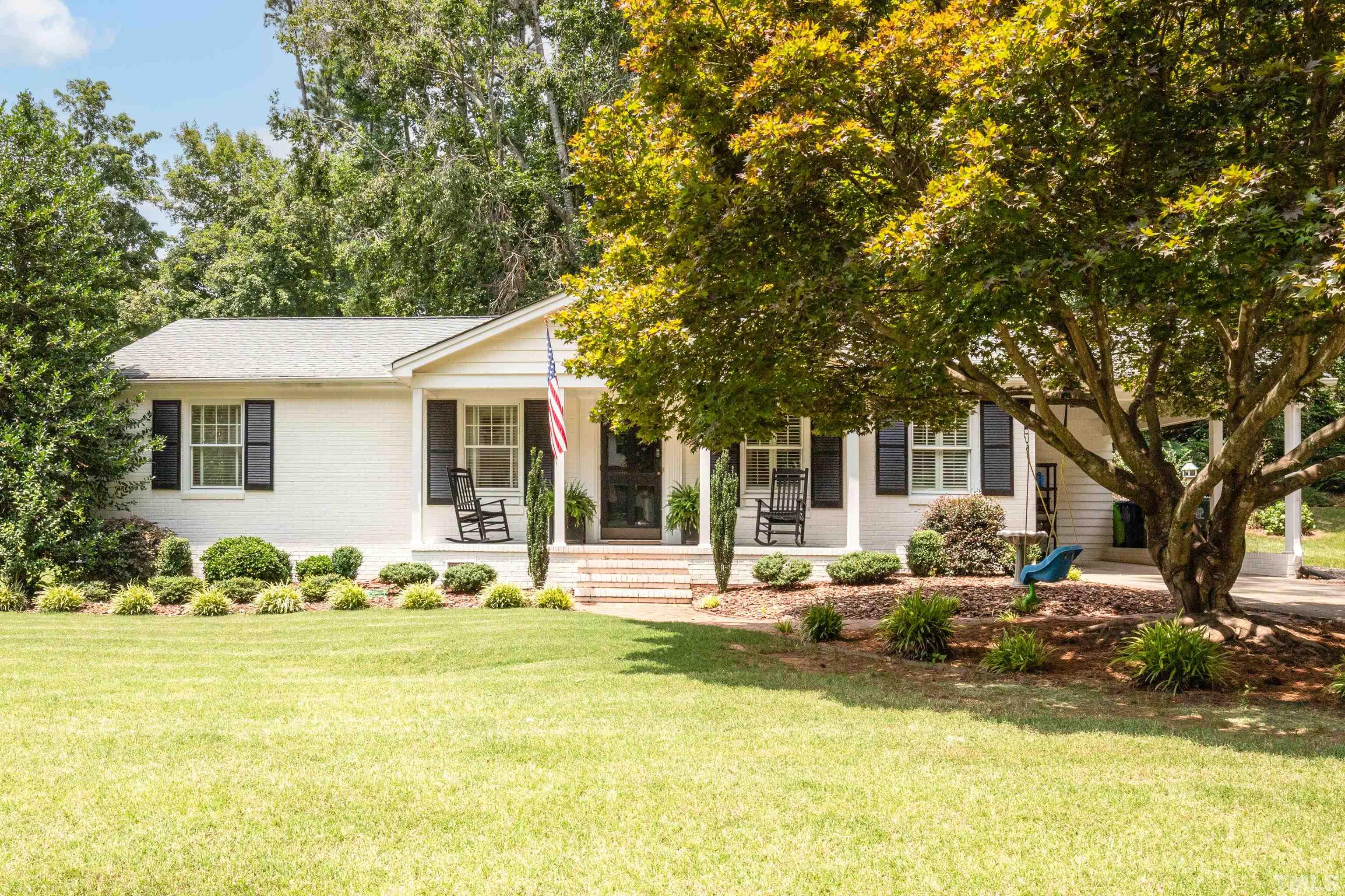 816 Davidson Street Raleigh, NC 27609 - Photo 2 of 36 a front view of a house with swimming pool having outdoor seating