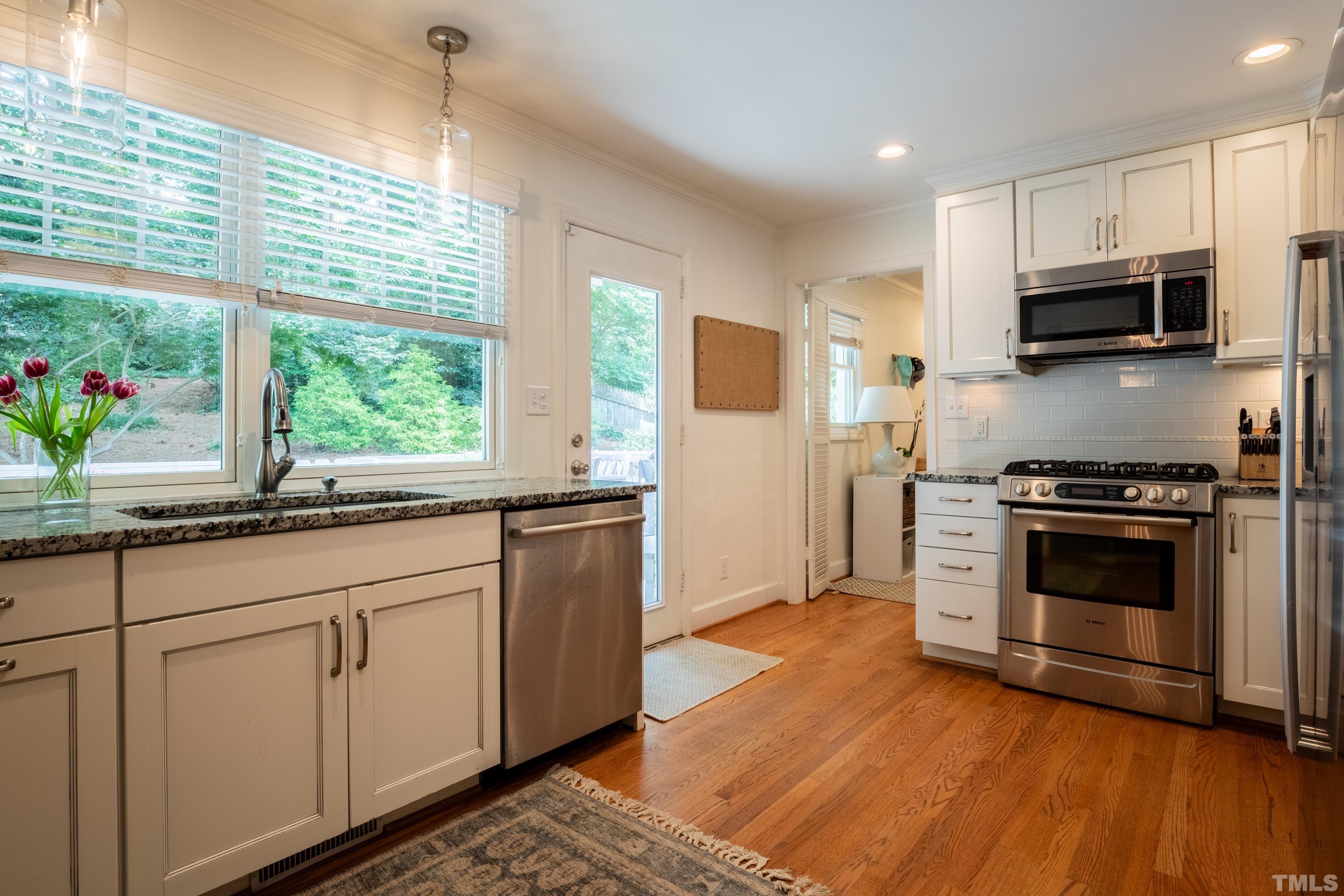 816 Davidson Street Raleigh, NC 27609 - Photo 10 of 36 a kitchen with stainless steel appliances granite countertop a stove a sink and a refrigerator