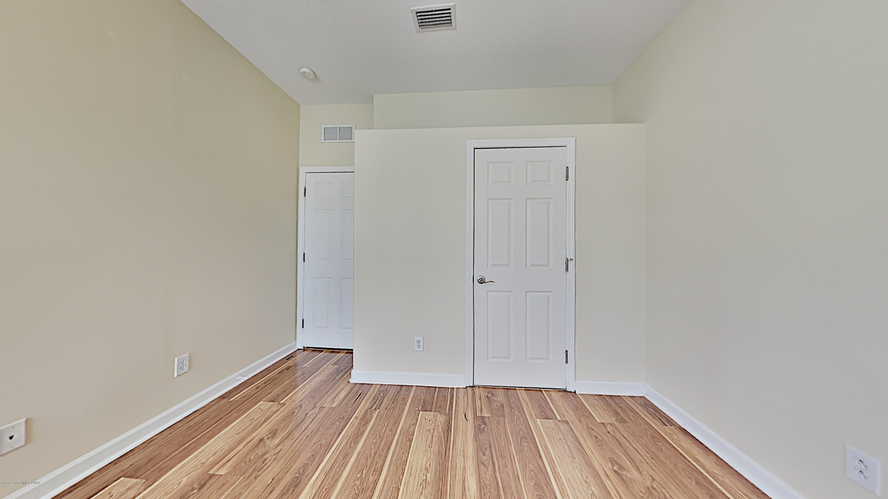 830 Riviera Drive Northeast Palm Bay, FL 32905 - Photo 15 of 21 a view of an empty room with wooden floor