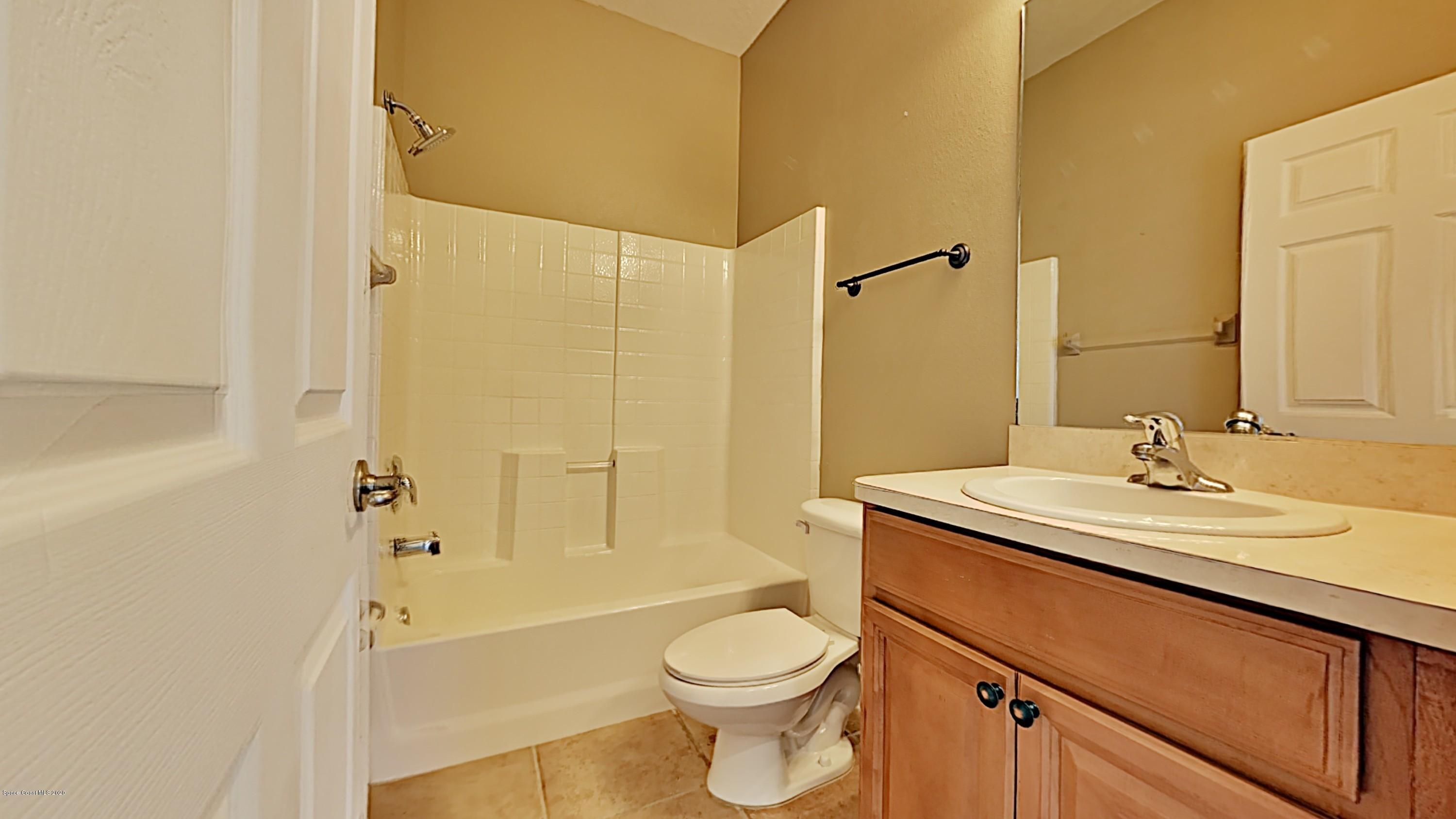 830 Riviera Drive Northeast Palm Bay, FL 32905 - Photo 18 of 21 a bathroom with a sink a toilet and shower