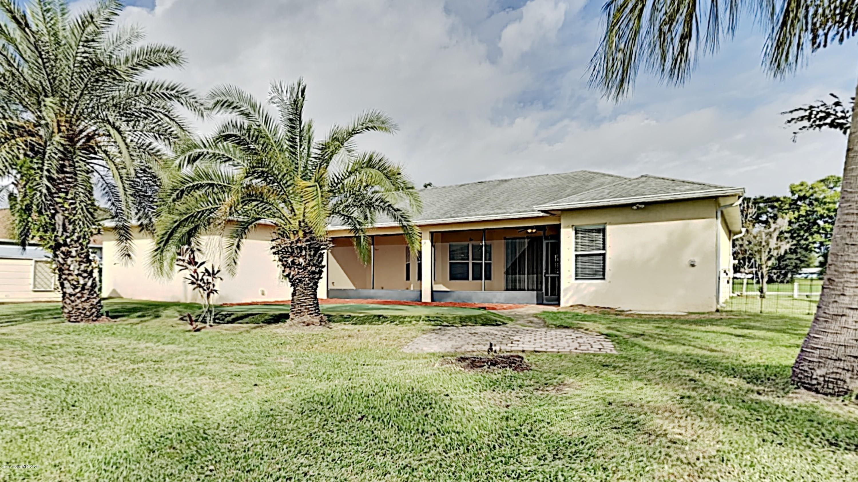 830 Riviera Drive Northeast Palm Bay, FL 32905 - Photo 20 of 21 a front view of a house with garden