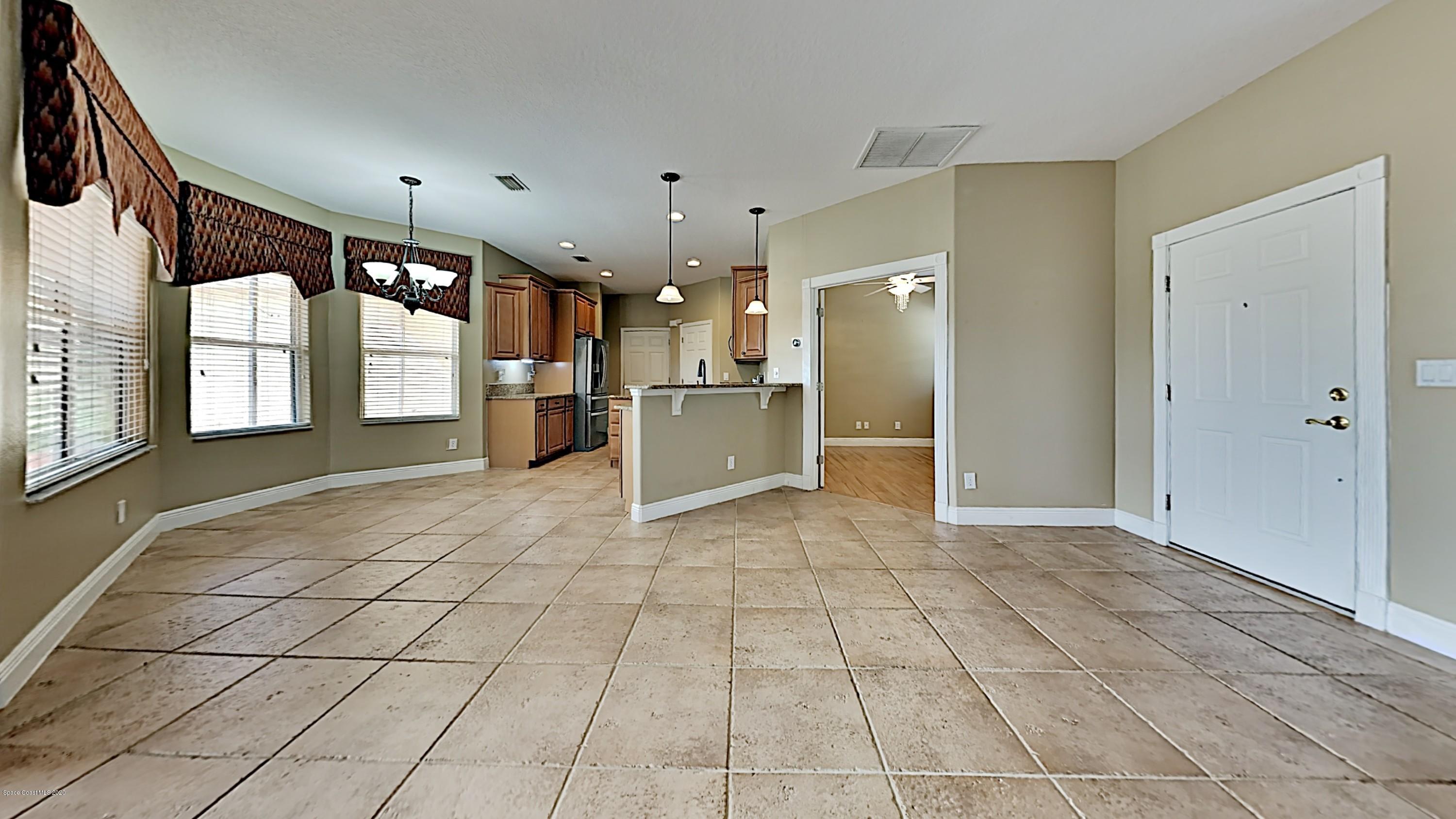 830 Riviera Drive Northeast Palm Bay, FL 32905 - Photo 7 of 21 a view of a electric appliances in kitchen and empty room with windows