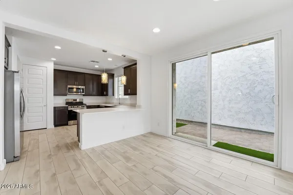 a kitchen with stainless steel appliances granite countertop a sink stove and cabinets
