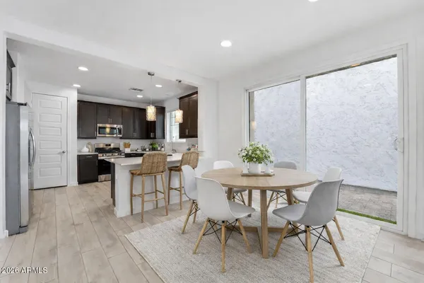 a kitchen with sink a microwave a stove and cabinets