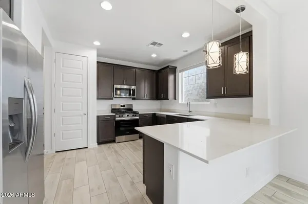 a large kitchen with cabinets and stainless steel appliances