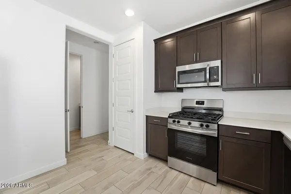 a kitchen with stainless steel appliances granite countertop a stove and a sink