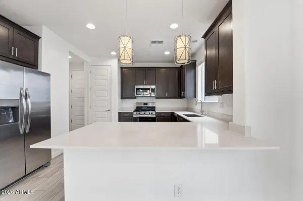 an empty room with closet and windows
