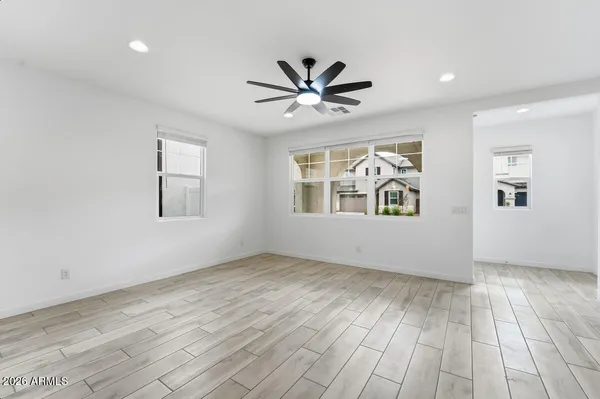 a living room with furniture a flat screen tv and a large window