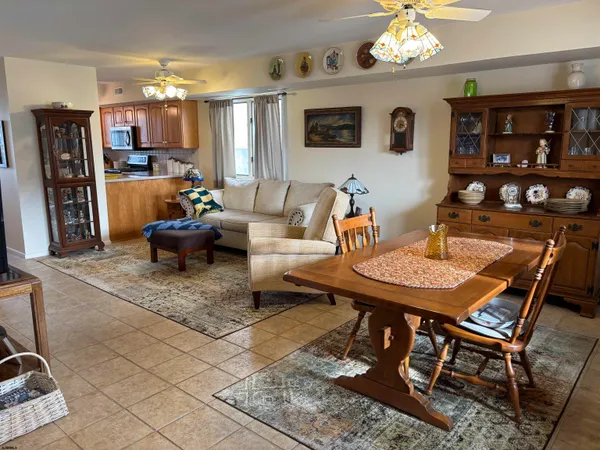 a living room with furniture a rug and a large window