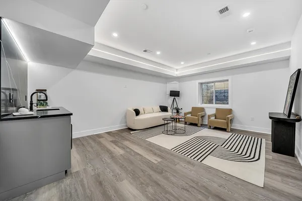 a living room with furniture and a wooden floor