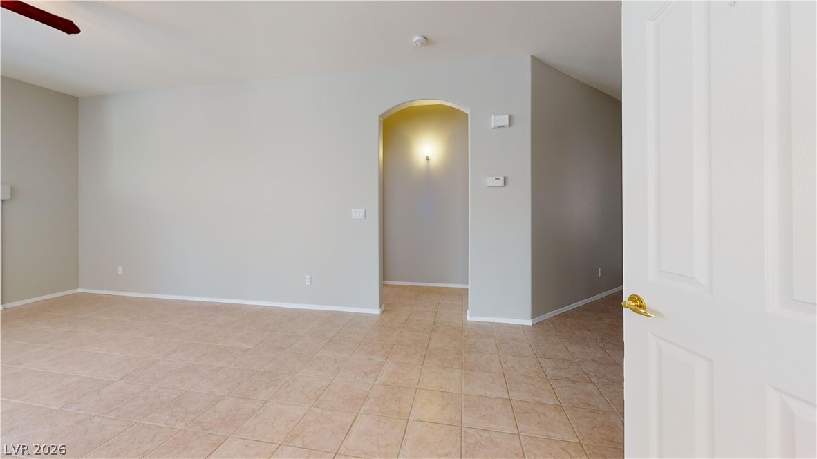 3591 Driving Range Street Las Vegas, NV 89122 - Photo 69 of 79 This expansive room offers versatile living with durable tile flooring, ready for personalized design.