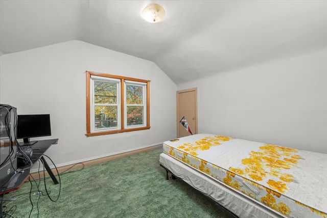 a living room with a bed and a table