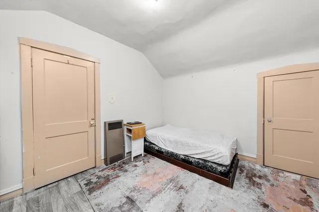 a bedroom with a bed and a dresser