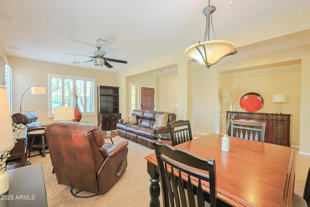 a living room with furniture a chandelier and a wooden floor