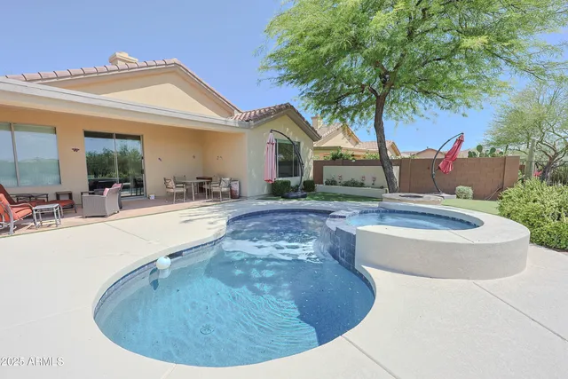 a view of a house with swimming pool and a porch