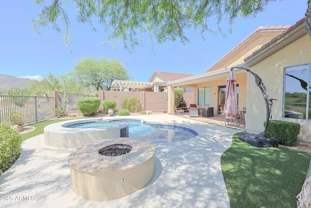 a view of swimming pool with outdoor seating and plants