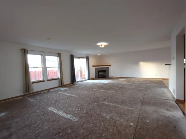 a view of empty room with a fireplace